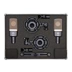 Pair of AKG C314 studio condenser microphones with black bodies and gold-colored grille, positioned side by side on a professional audio setup.