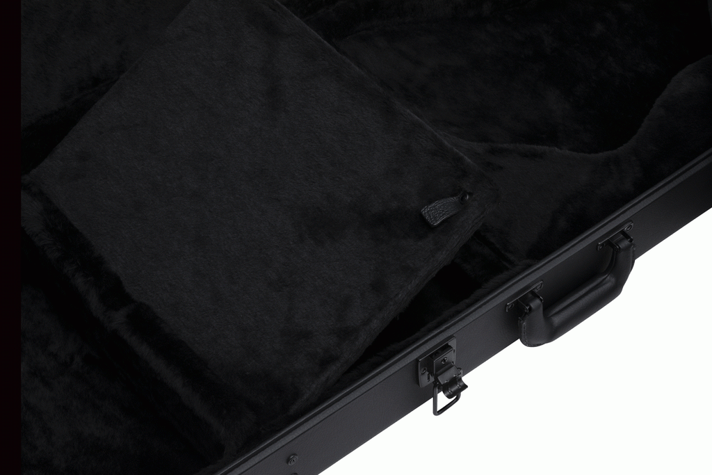 Gibson Firebird electric guitar hardshell case with black exterior and sturdy handle for secure transport and protection.