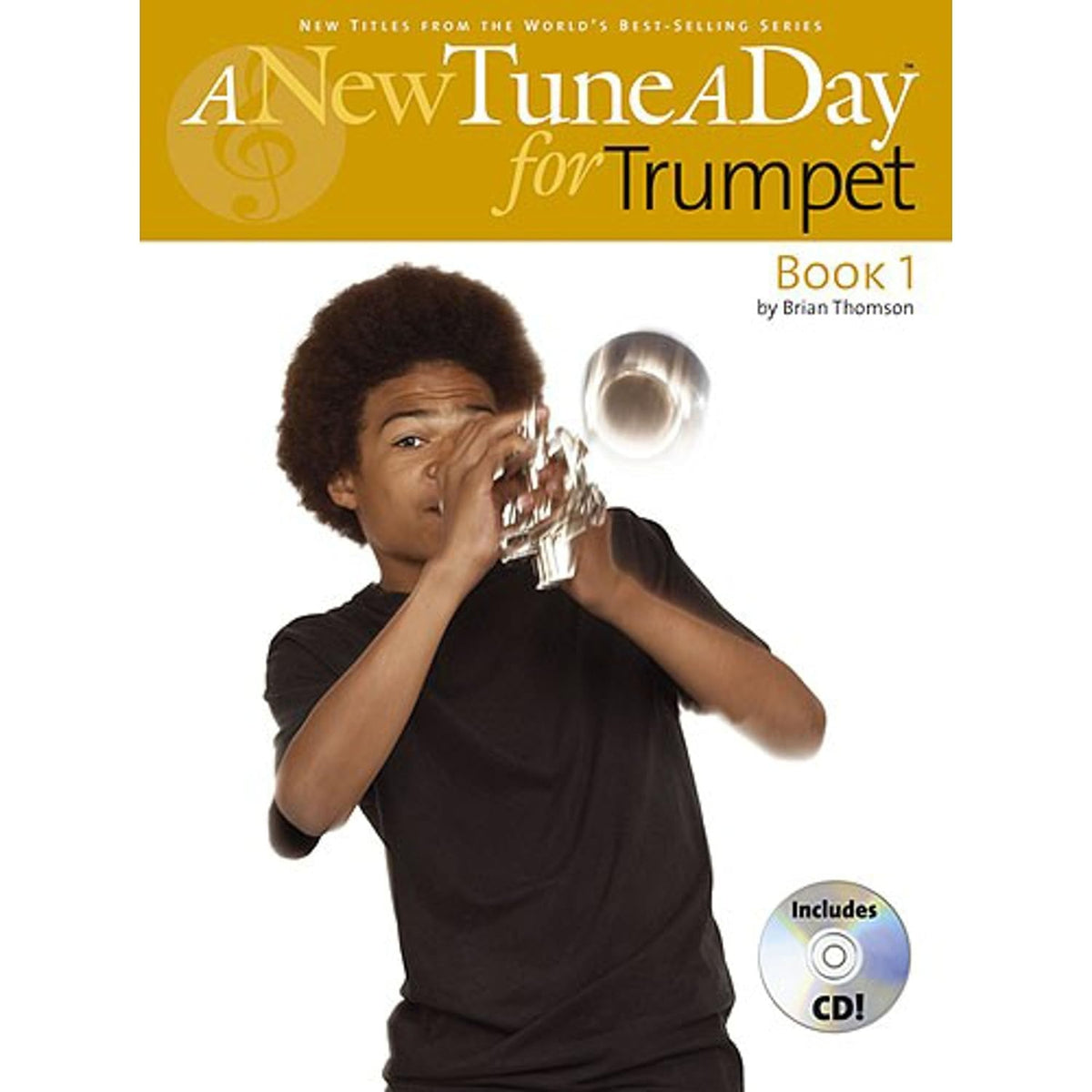Open page of "A New Tune A Day for Trumpet Book 1," a brass and woodwind music book with musical notation and instrument illustrations.
