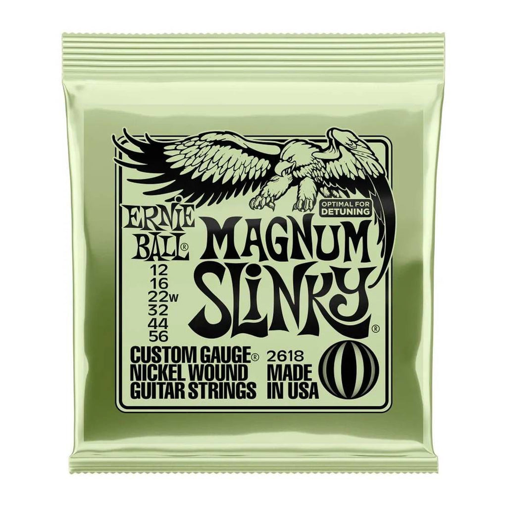Ernie Ball Magnum Slinky Olive electric guitar strings set with 12-56 gauge, displayed on a guitar fretboard.