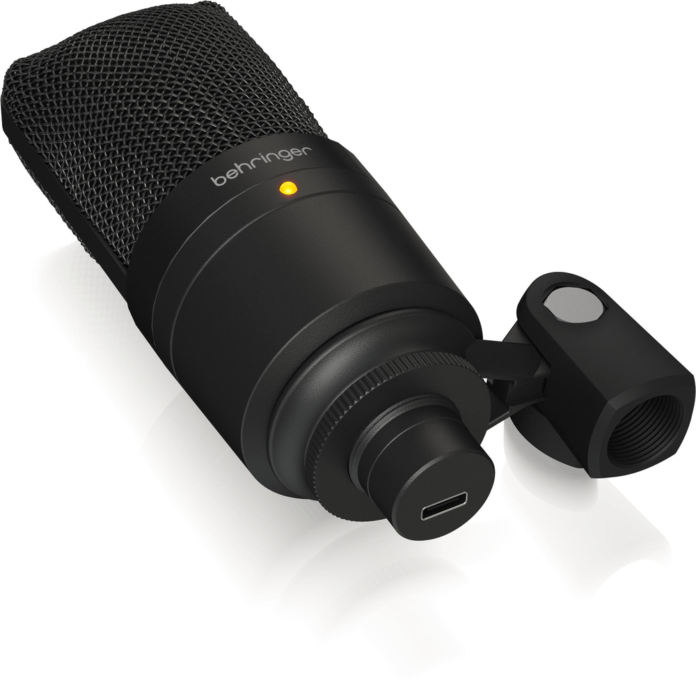 Behringer D3 USB studio microphone in black with adjustable stand and accessories for podcast recording.