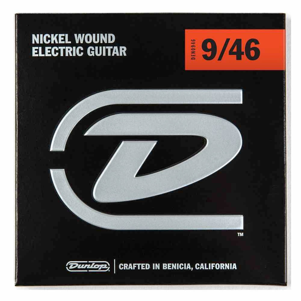 Dunlop DEN946 electric guitar strings, light top heavy bottom 9-46, shown on guitar neck with packaging in background.
