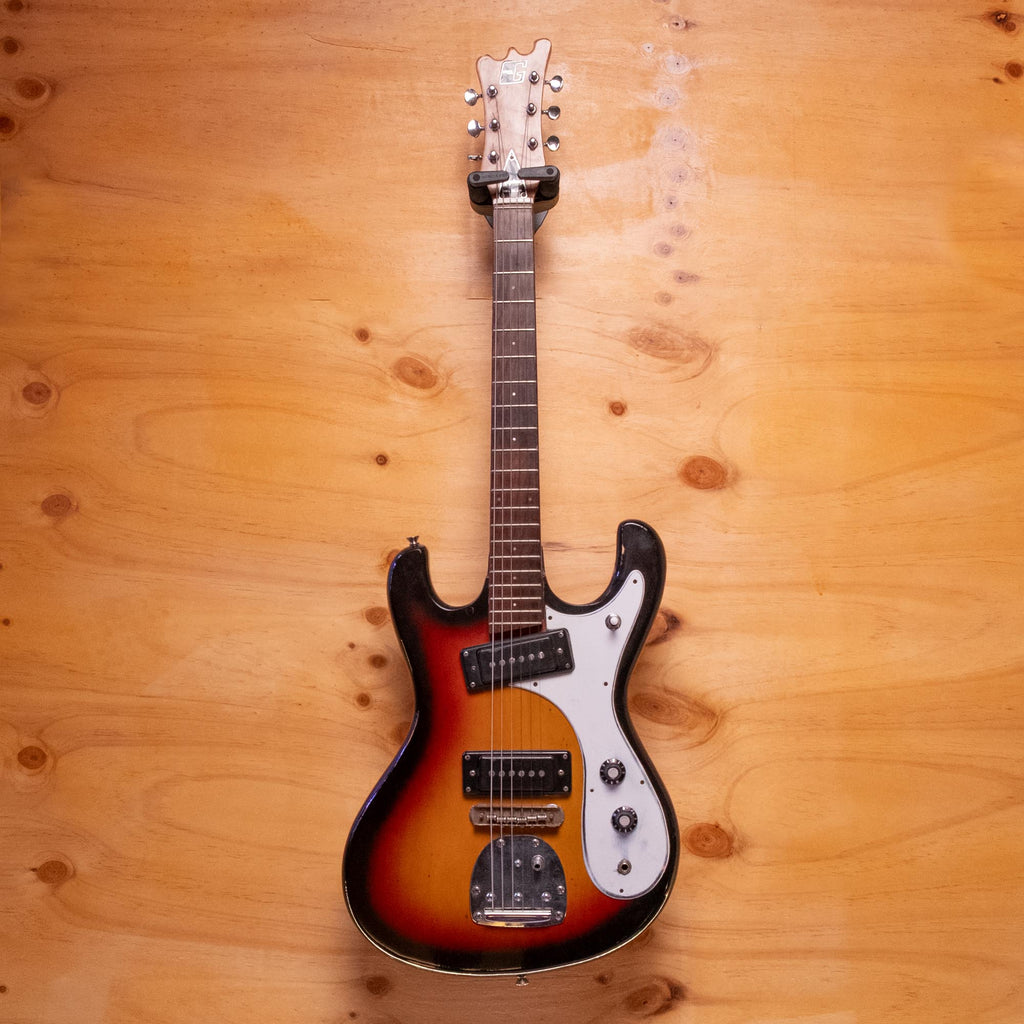 Preloved Guyatone electric guitar with sunburst finish, solid body, and six strings, displayed on a stand.