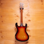 Preloved Guyatone electric guitar with a sleek body and six strings, shown on a stand with a sunlit background.