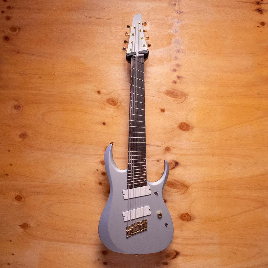 Ibanez RGDMS8 multi-scale 8-string electric guitar in classic silver matte, featuring sleek body and detailed bridge design.