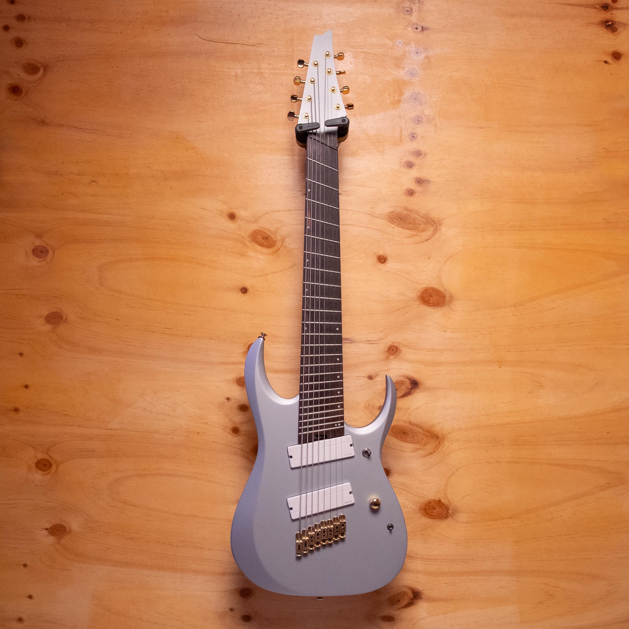 Ibanez RGDMS8 multi-scale 8-string electric guitar in classic silver matte, featuring sleek body and detailed bridge design.