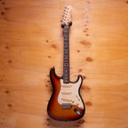 Fender Stratocaster electric guitar made in Japan with sunburst finish and maple neck, positioned on a stand.