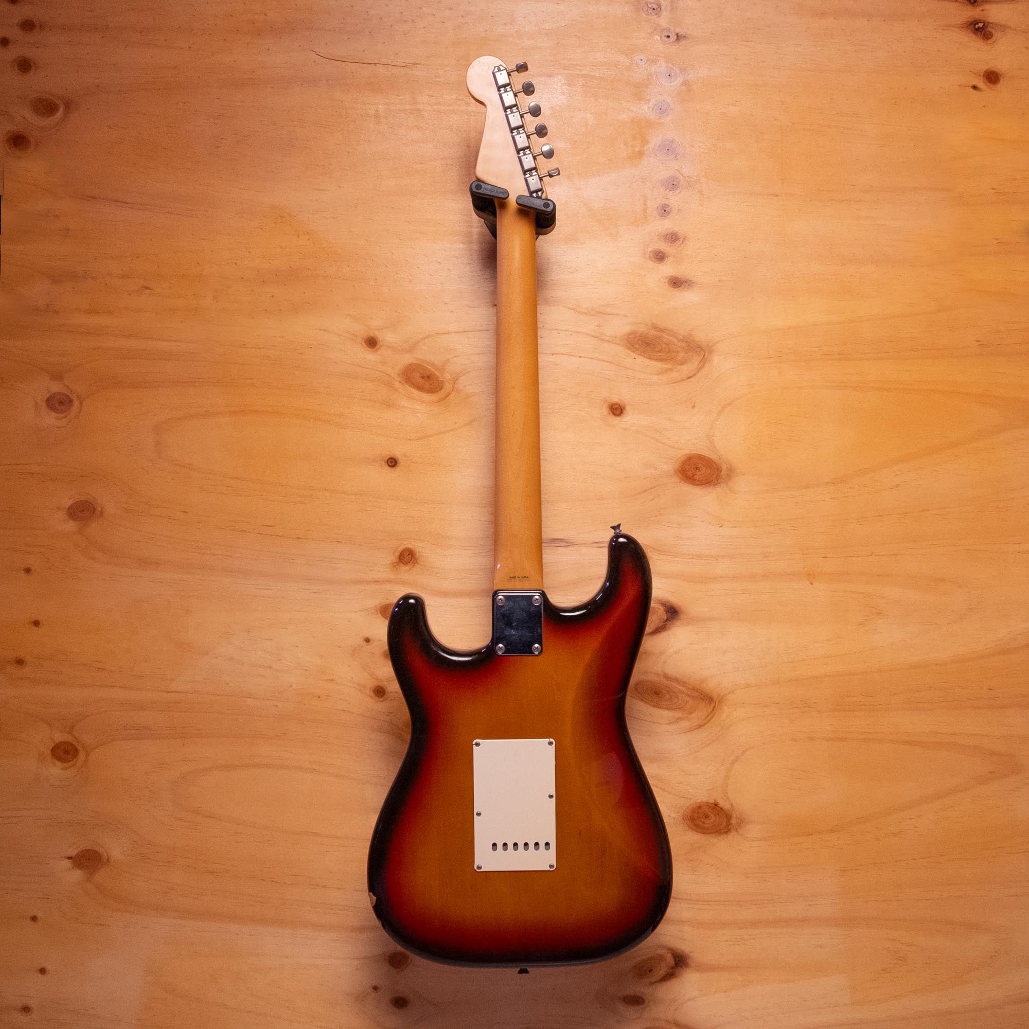 Fender Stratocaster electric guitar made in Japan, showing the body, pickguard, and pickups in a natural setting.