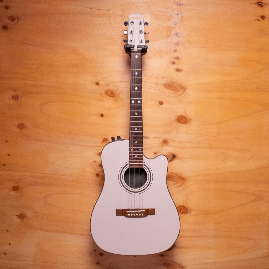 Preloved Daion hybrid electric acoustic guitar, Japanese-made, showing the body, strings, and wood finish of the guitar.
