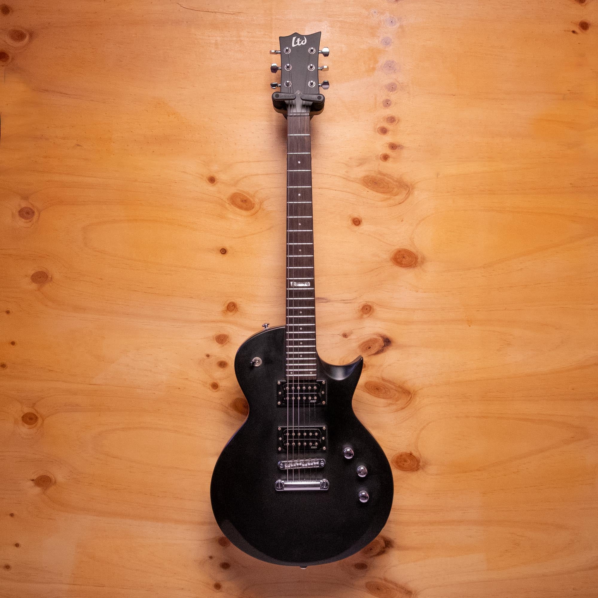ESP LTD EC-50 electric guitar with a sleek black finish, featuring a solid body, two humbucker pickups, and a maple neck.