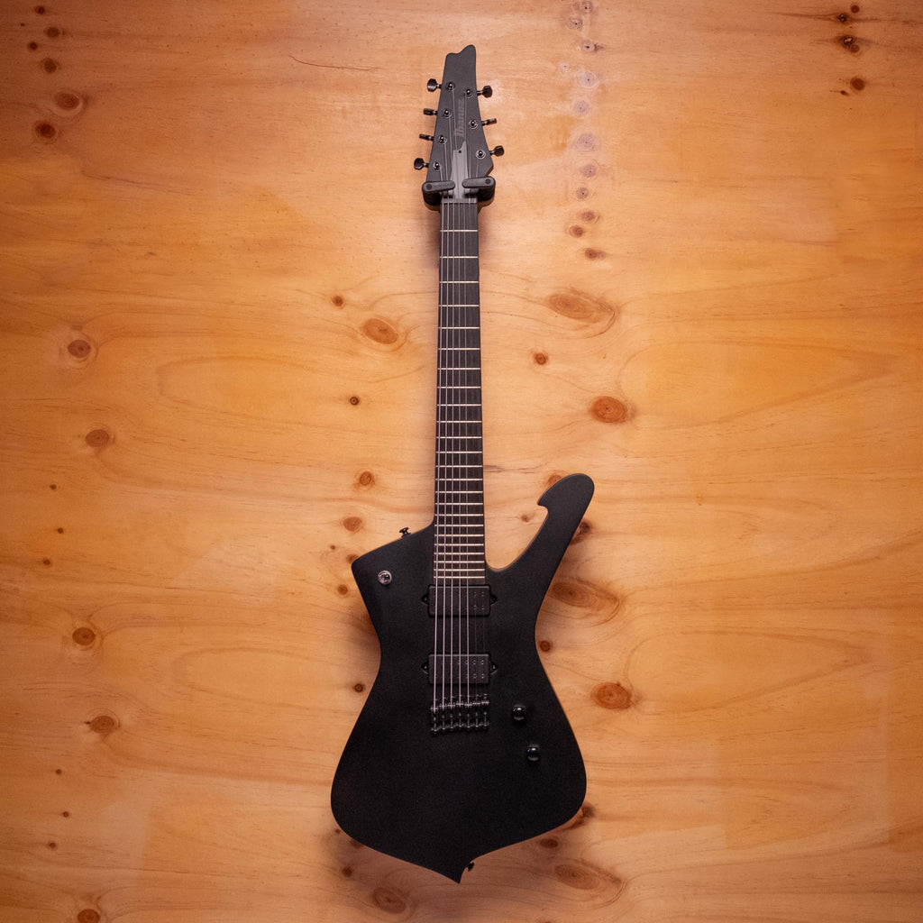 Ibanez ICTB721 Iceman Iron Label 7-string electric guitar in black flat, showing the distinctive body shape and six-string neck.