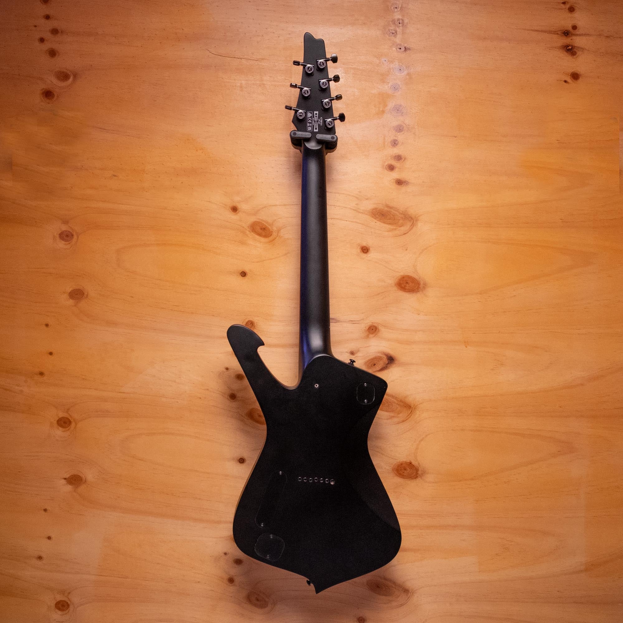 Ibanez ICTB721 Iceman Iron Label 7-string electric guitar in black flat, showing the body, neck, and headstock details.