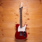 Fender Player II Telecaster electric guitar in transparent cherry finish with maple neck and black hardware on a stand.