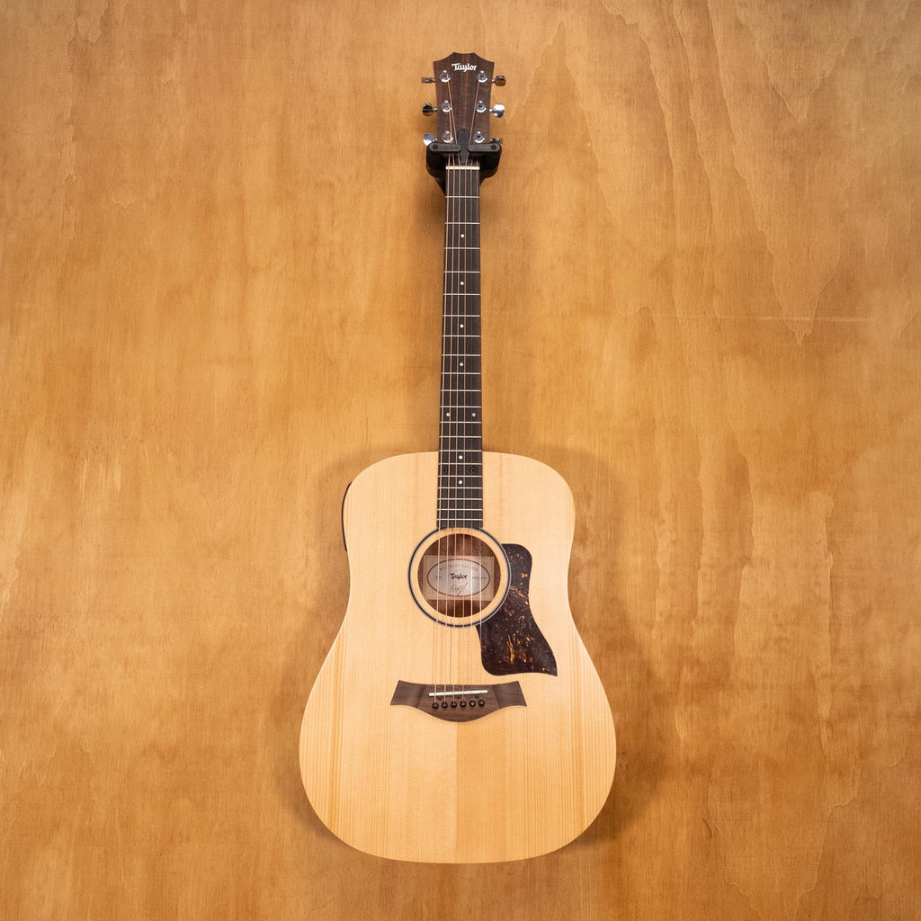 Taylor Big Baby acoustic guitar with pickup in walnut wood, showing the guitar body, fretboard, and pickup system.