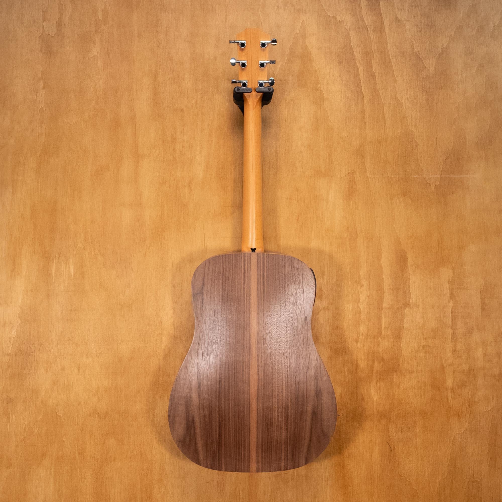 Taylor Big Baby acoustic guitar with pickup in walnut finish, close-up of the guitar body and soundhole.