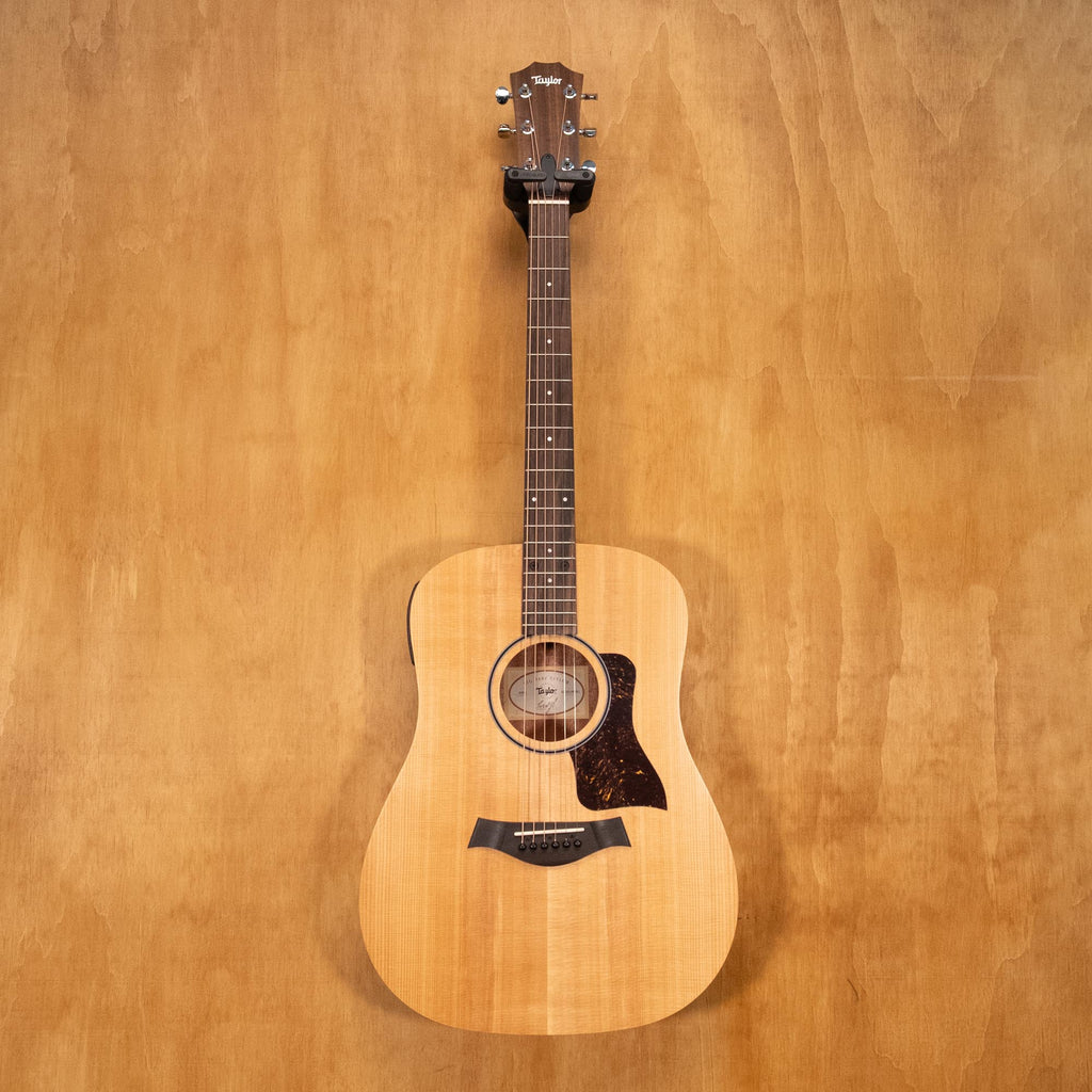 Taylor Big Baby acoustic guitar with pickup in walnut wood, showing the front view of the guitar with its natural finish.