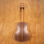 Taylor Big Baby acoustic guitar with pickup in walnut finish, showing the front view with detailed wood grain and hardware.