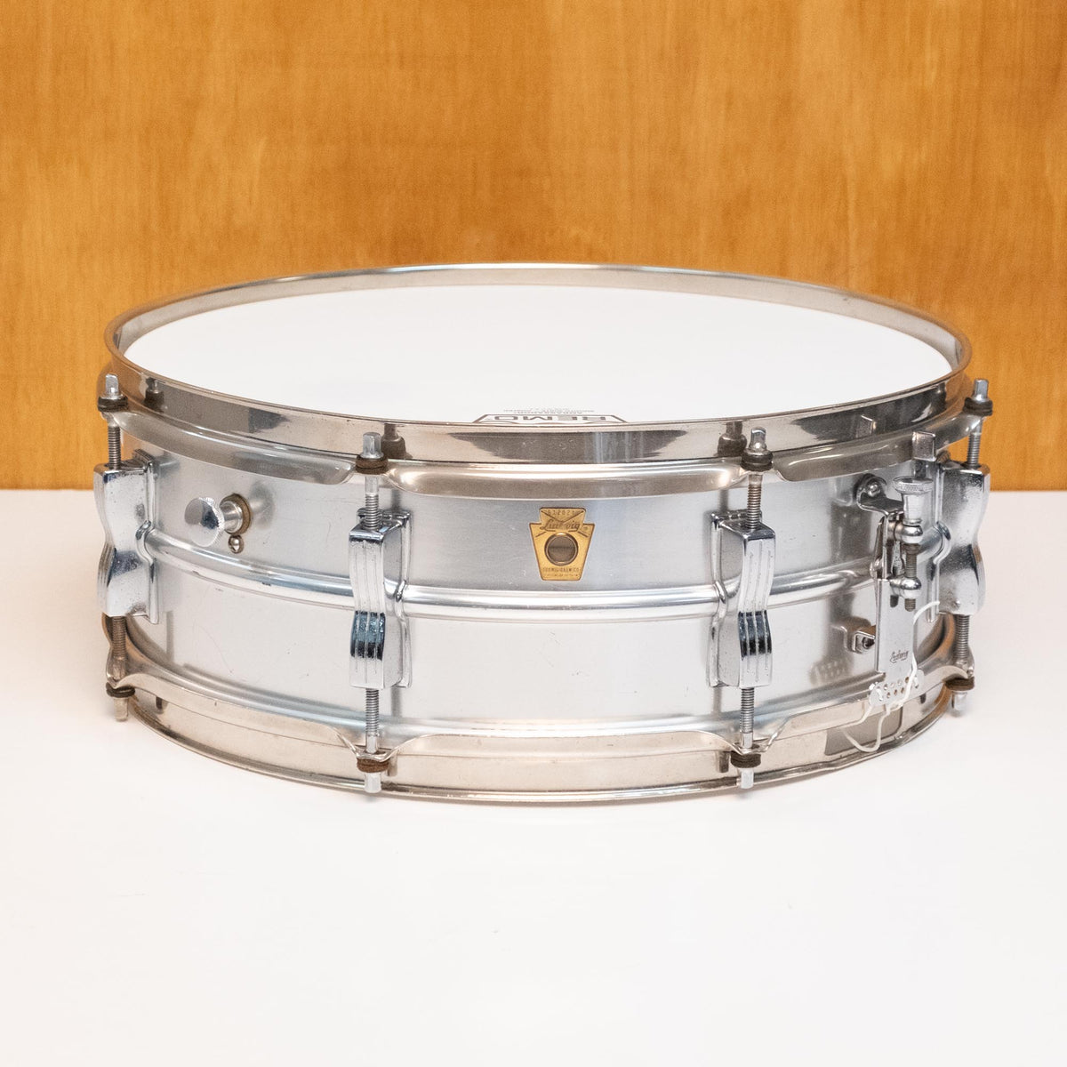 Ludwig L-404 '60s Acrolite 14x5 inch snare drum with metal shell and chrome hardware, viewed from the side.