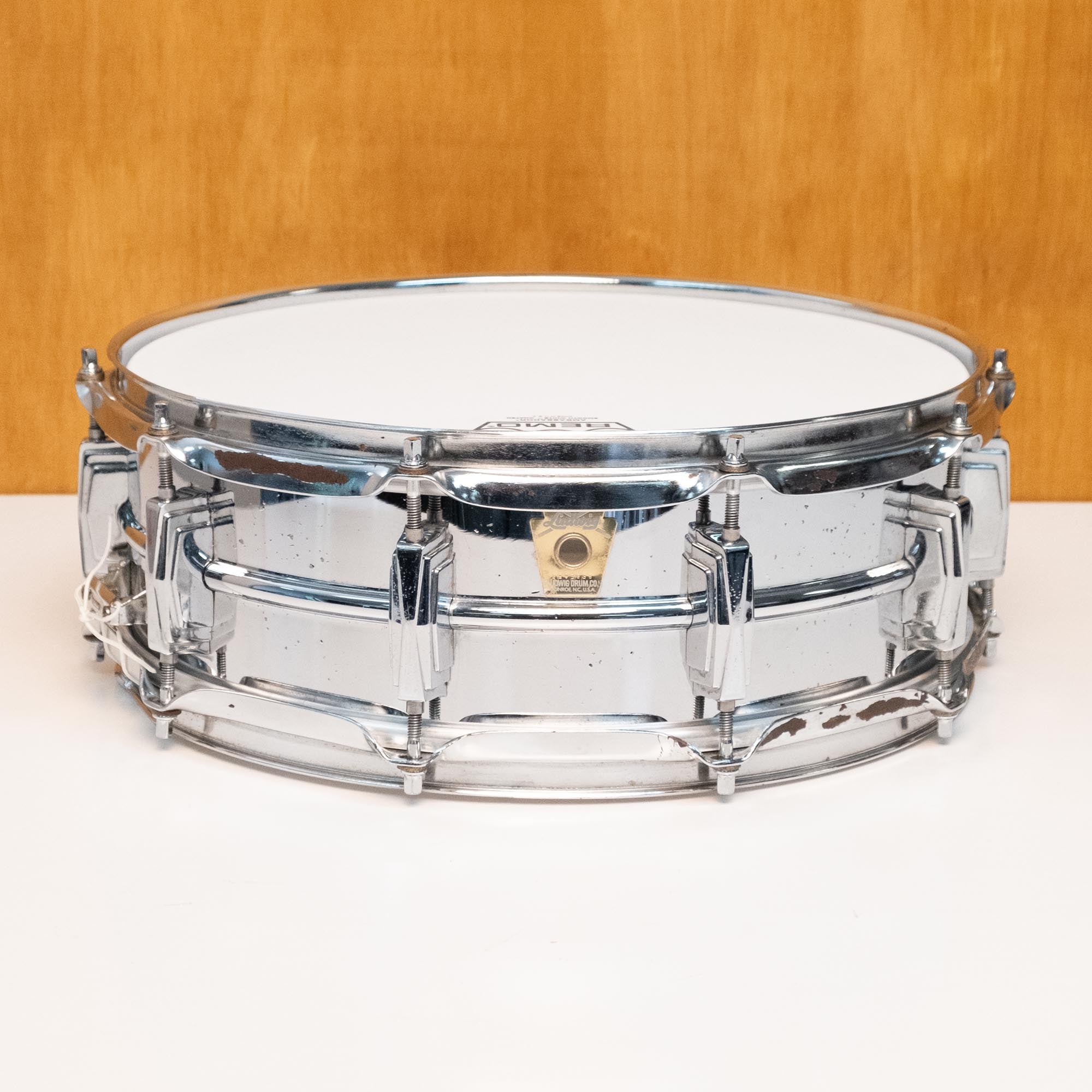 Ludwig LM400 Supraphonic 14x5 Radick snare drum, close-up of the metallic drum shell and hardware on a plain background.