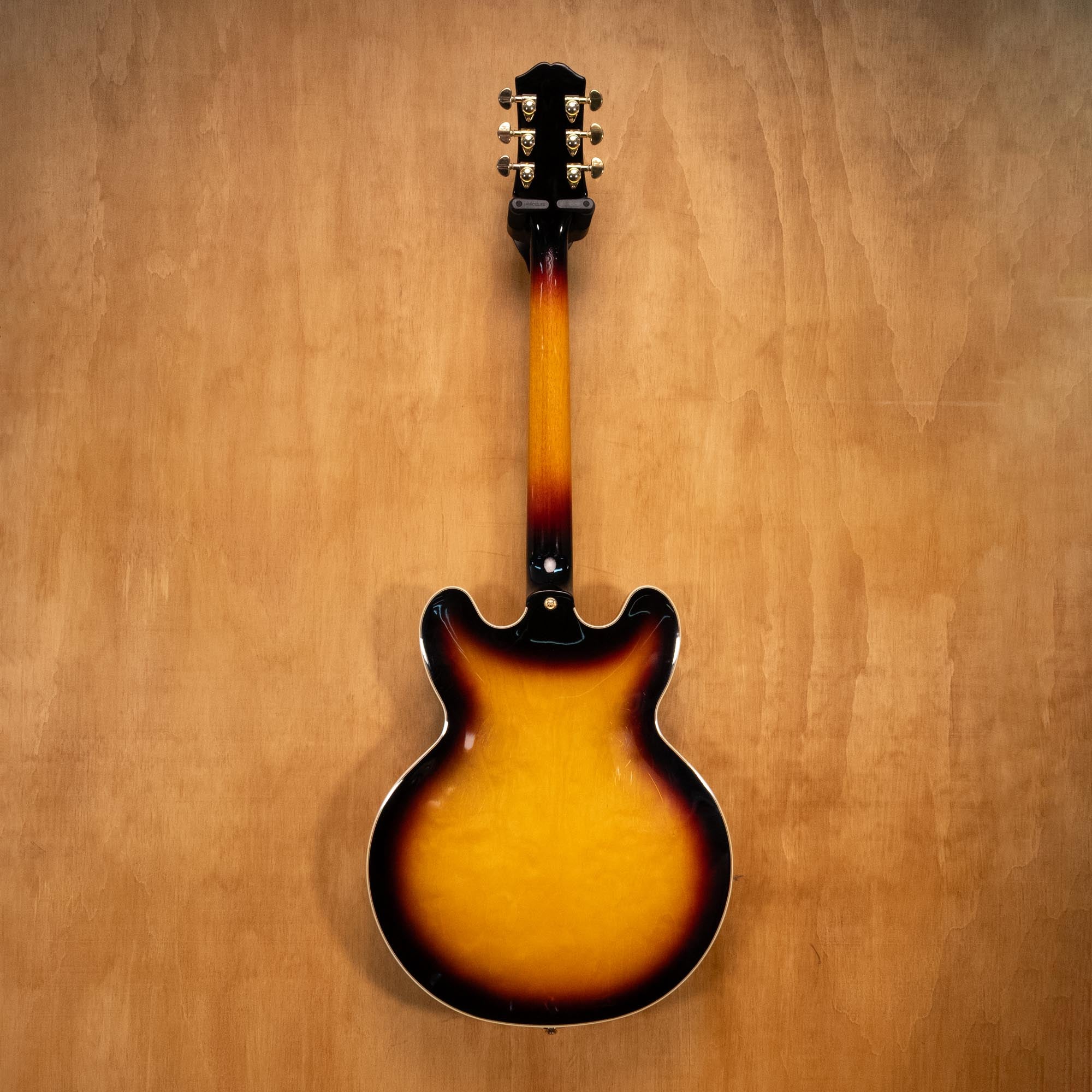 Left-handed Epiphone Sheraton electric guitar in vintage sunburst finish, showcasing its double-cutaway body and classic design.