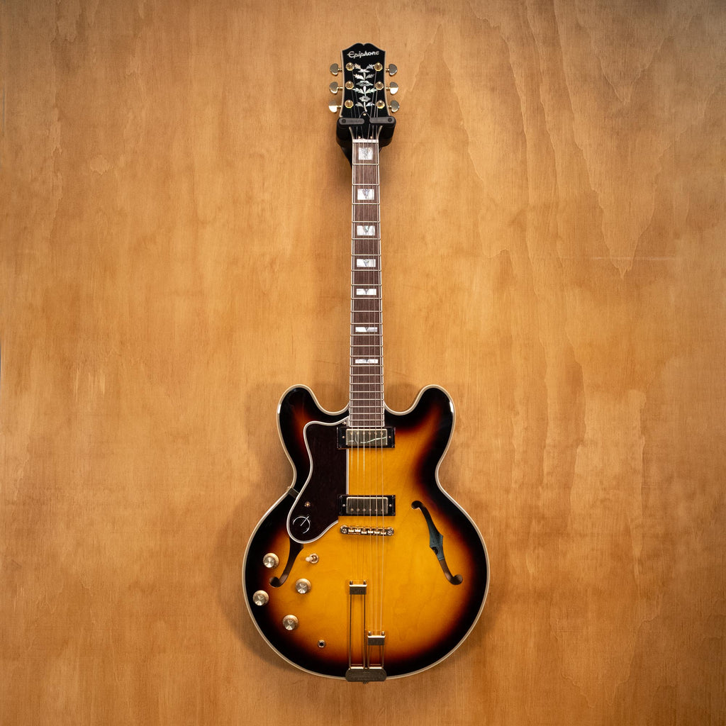 Left-handed Epiphone Sheraton electric guitar in vintage sunburst finish, showcasing the body, pickguard, and neck details.