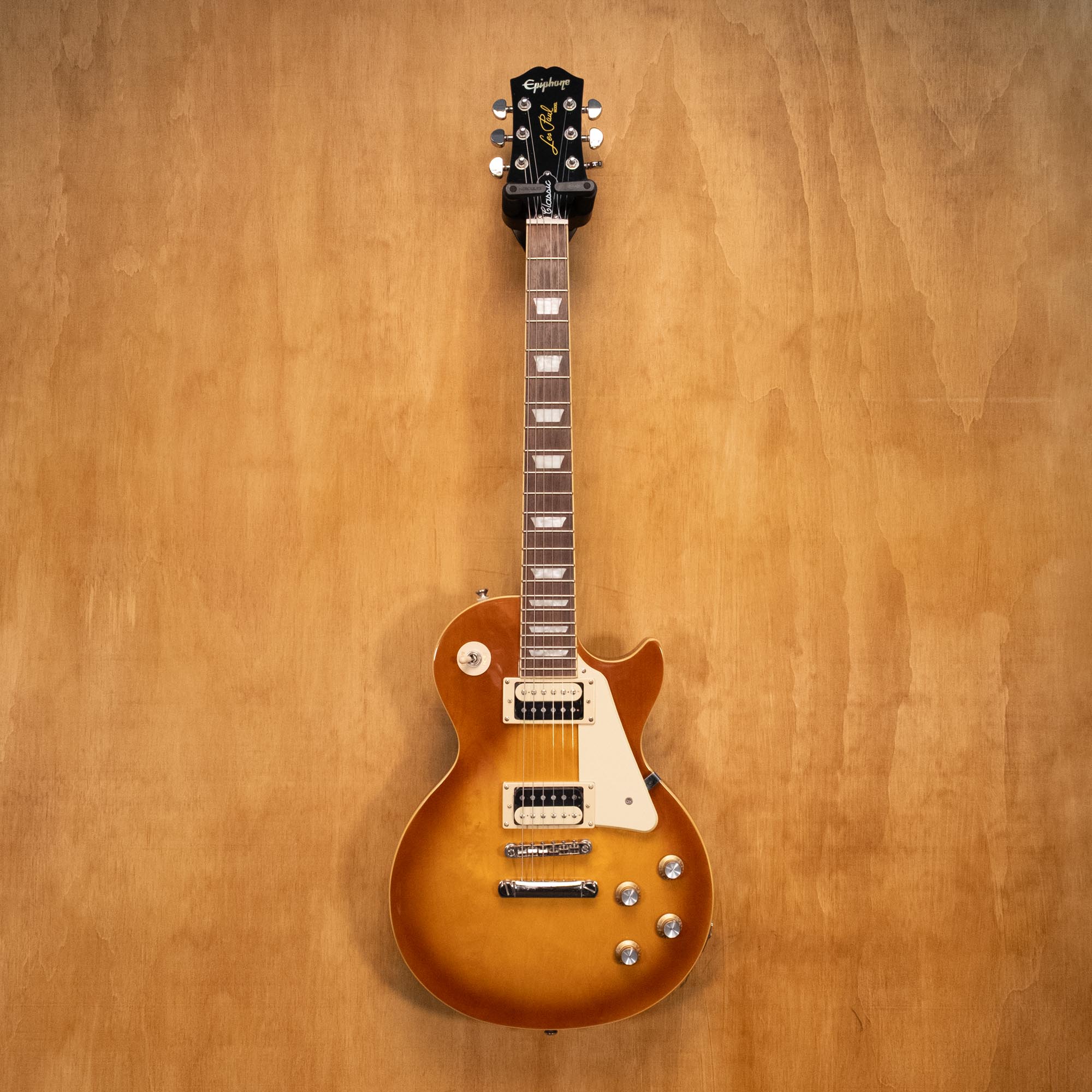 Epiphone Les Paul Classic electric guitar in honey burst finish, showcasing its wood grain, pickups, and hardware details.