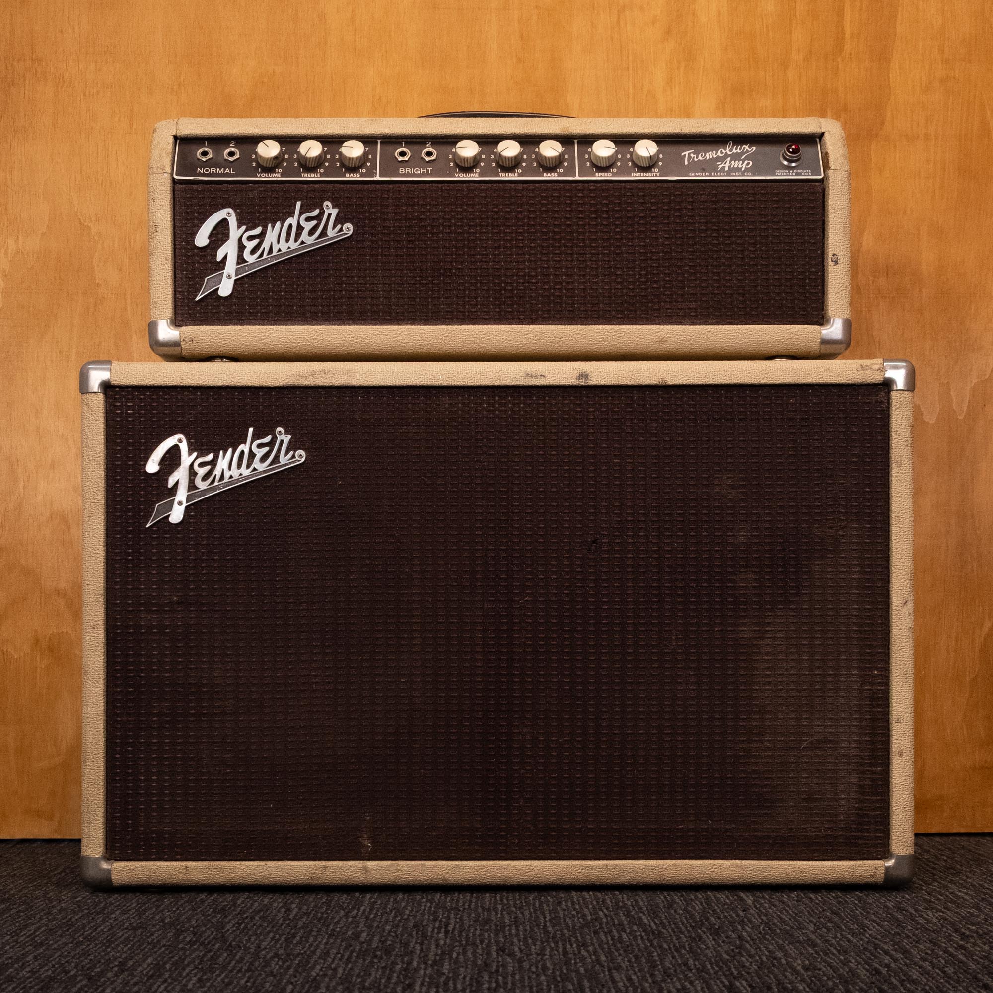Fender 1962 Tremolux 6G9-A 30-watt guitar amplifier head and cabinet, vintage tube amp with control knobs and speaker grille.
