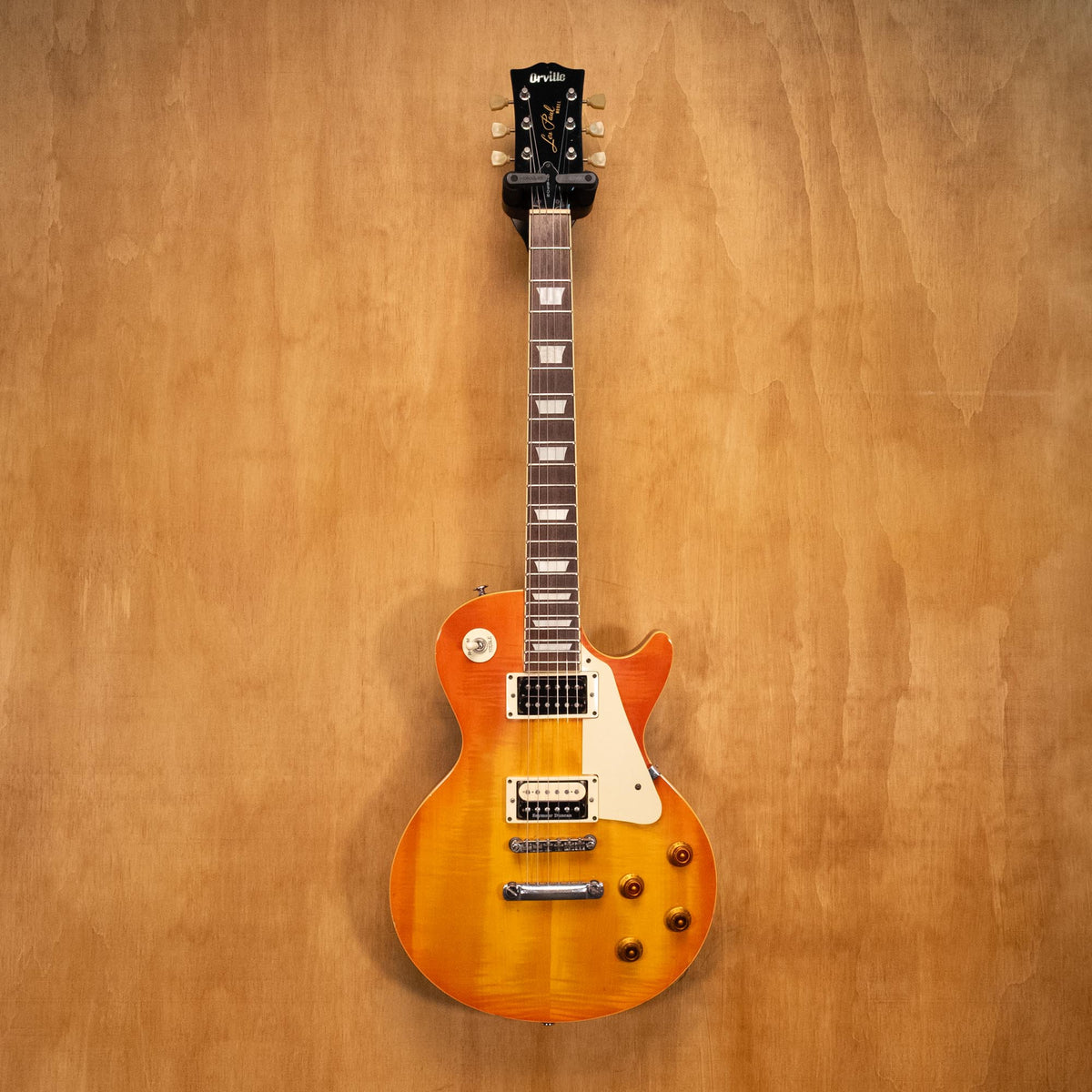 Orville LPS-75 electric guitar with sunburst finish, showing the body, neck, and pickups, on a plain background.