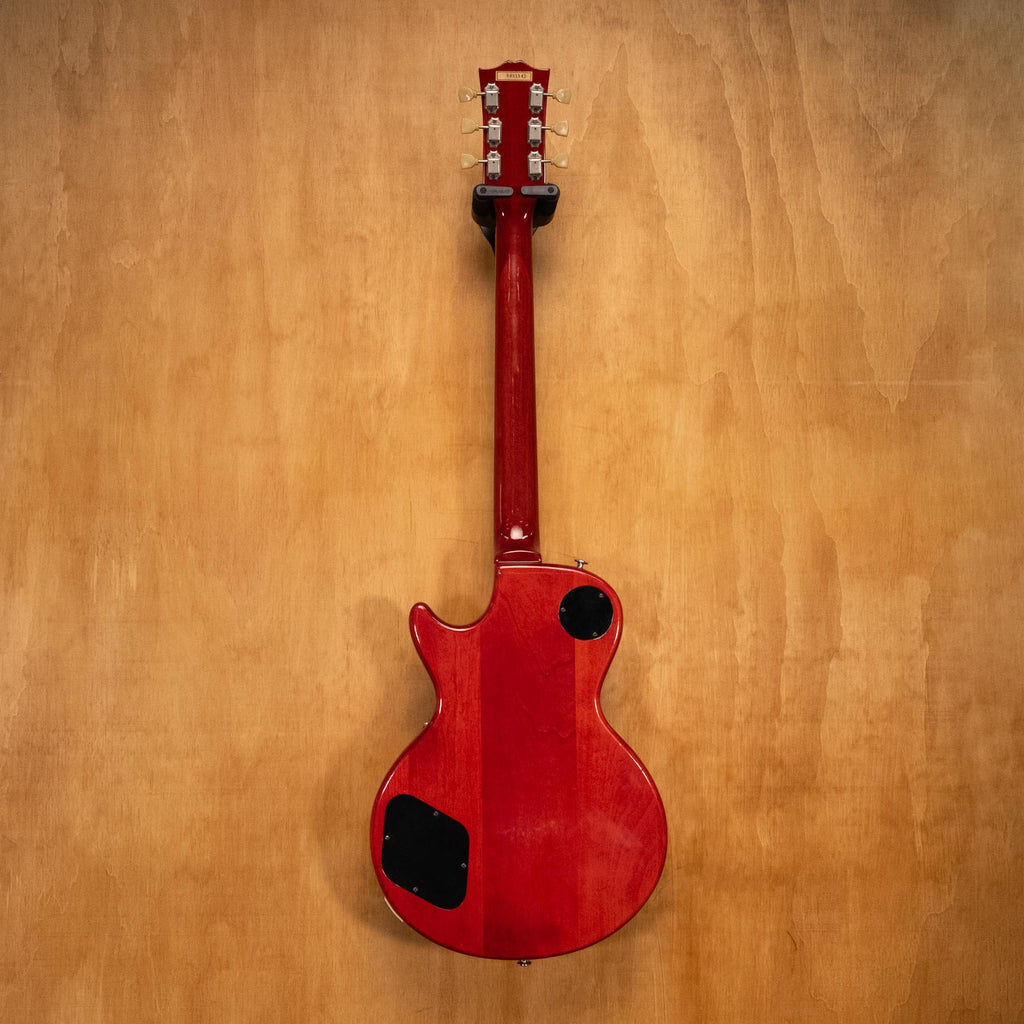 Orville LPS-75 electric guitar with sunburst finish, solid body, and vintage-style hardware, displayed on a stand.