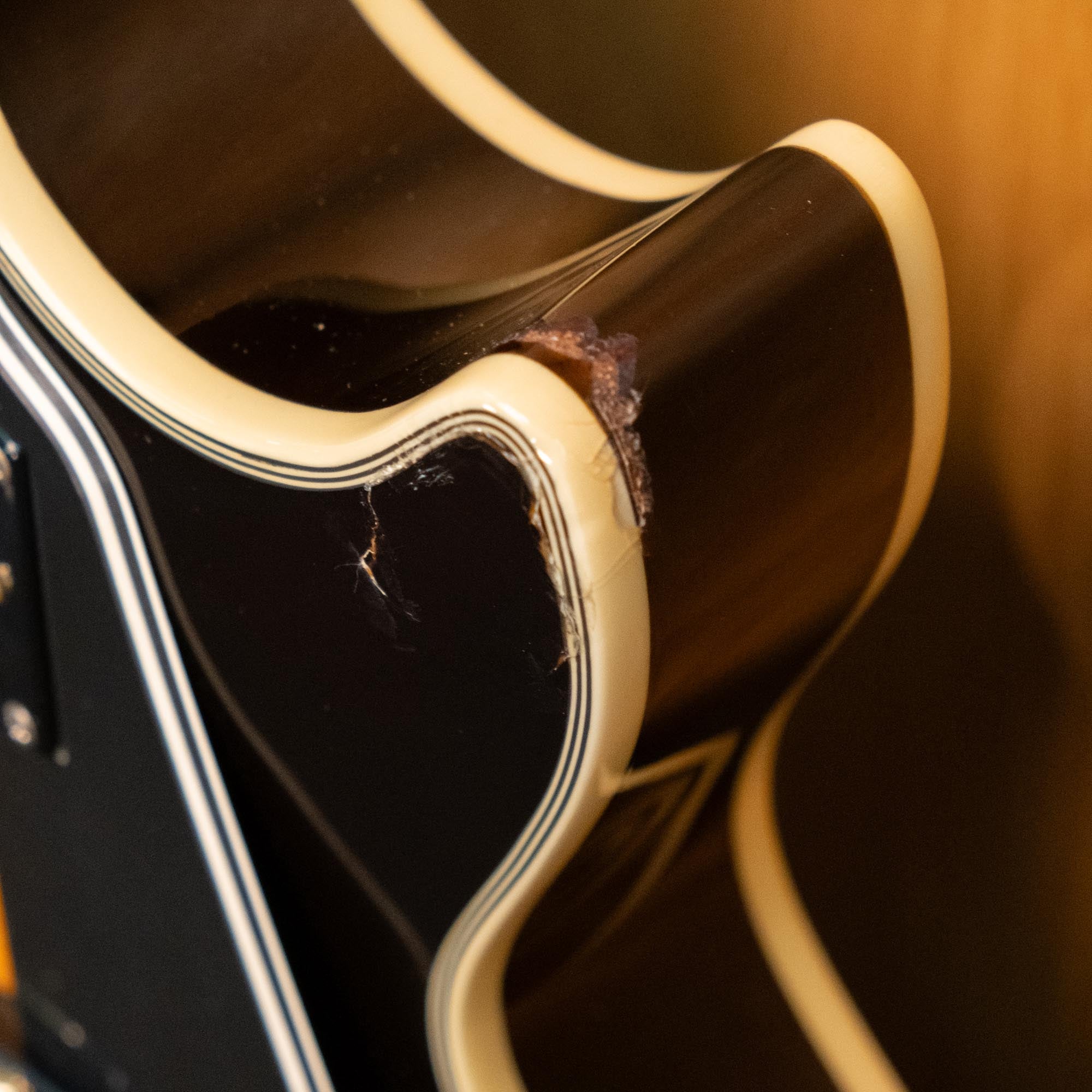 Epiphone Les Paul Custom Plus electric guitar with vintage sunburst finish, showcasing its body and neck details.