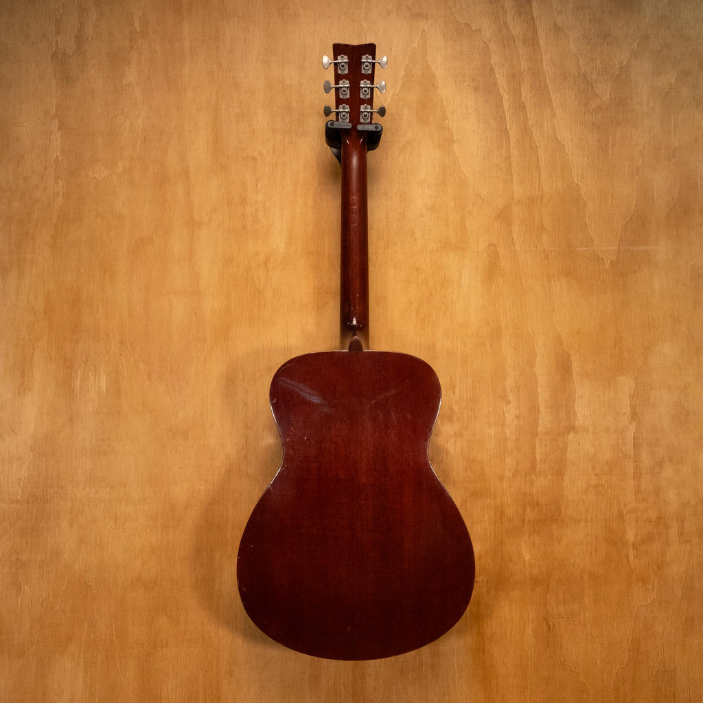 Yamaha FG-150 acoustic guitar, preowned, with natural wood finish, showcasing the body and strings in a close-up shot.