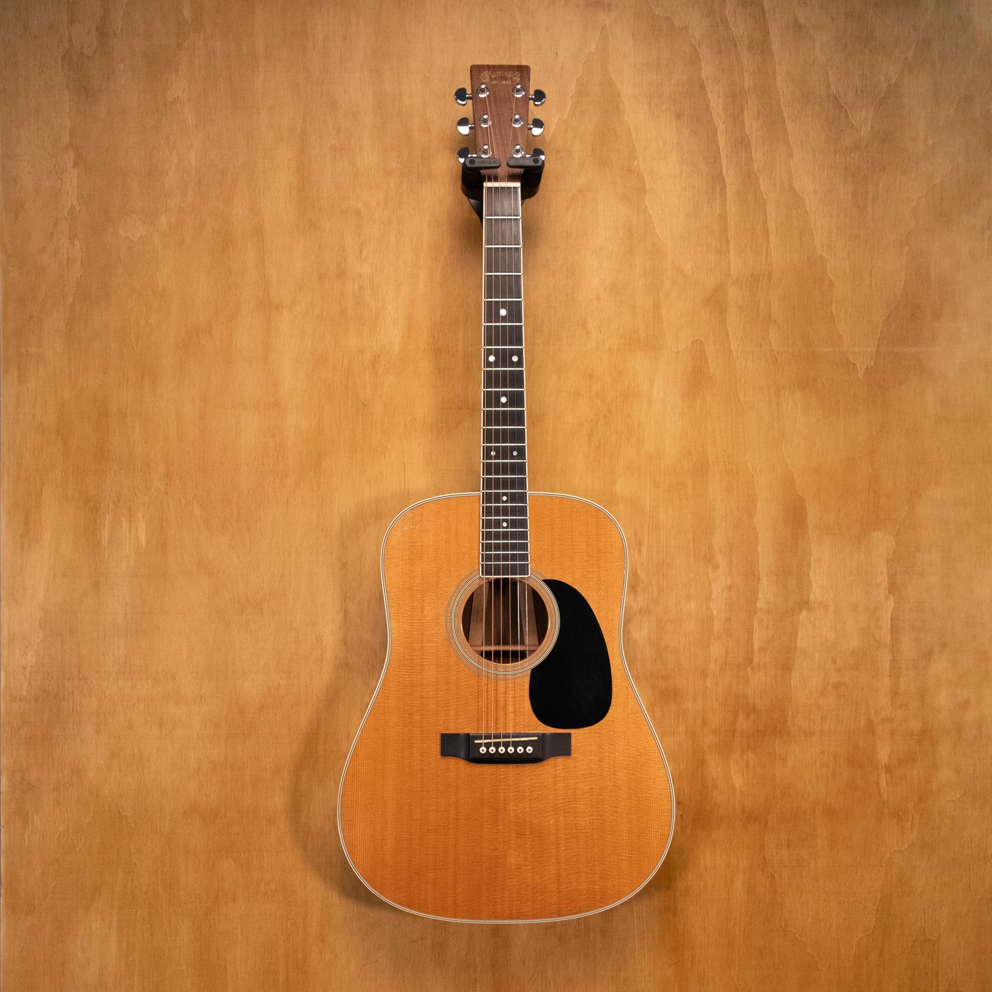 Martin D-35 dreadnought acoustic guitar with rich wood finish and six strings, shown in a close-up shot highlighting the body and fretboard.