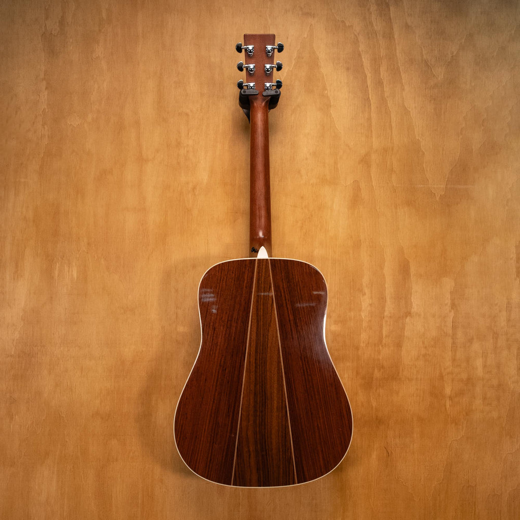 Martin D-35 dreadnought acoustic guitar with rich wood finish and six strings, shown resting on a stand.