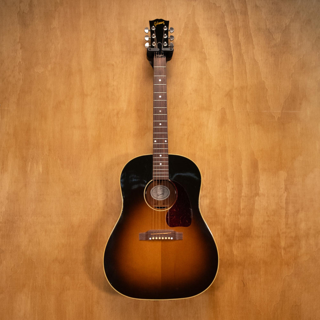 Gibson J-45 Standard acoustic guitar with sunburst finish, showing the body, soundhole, and guitar strings.