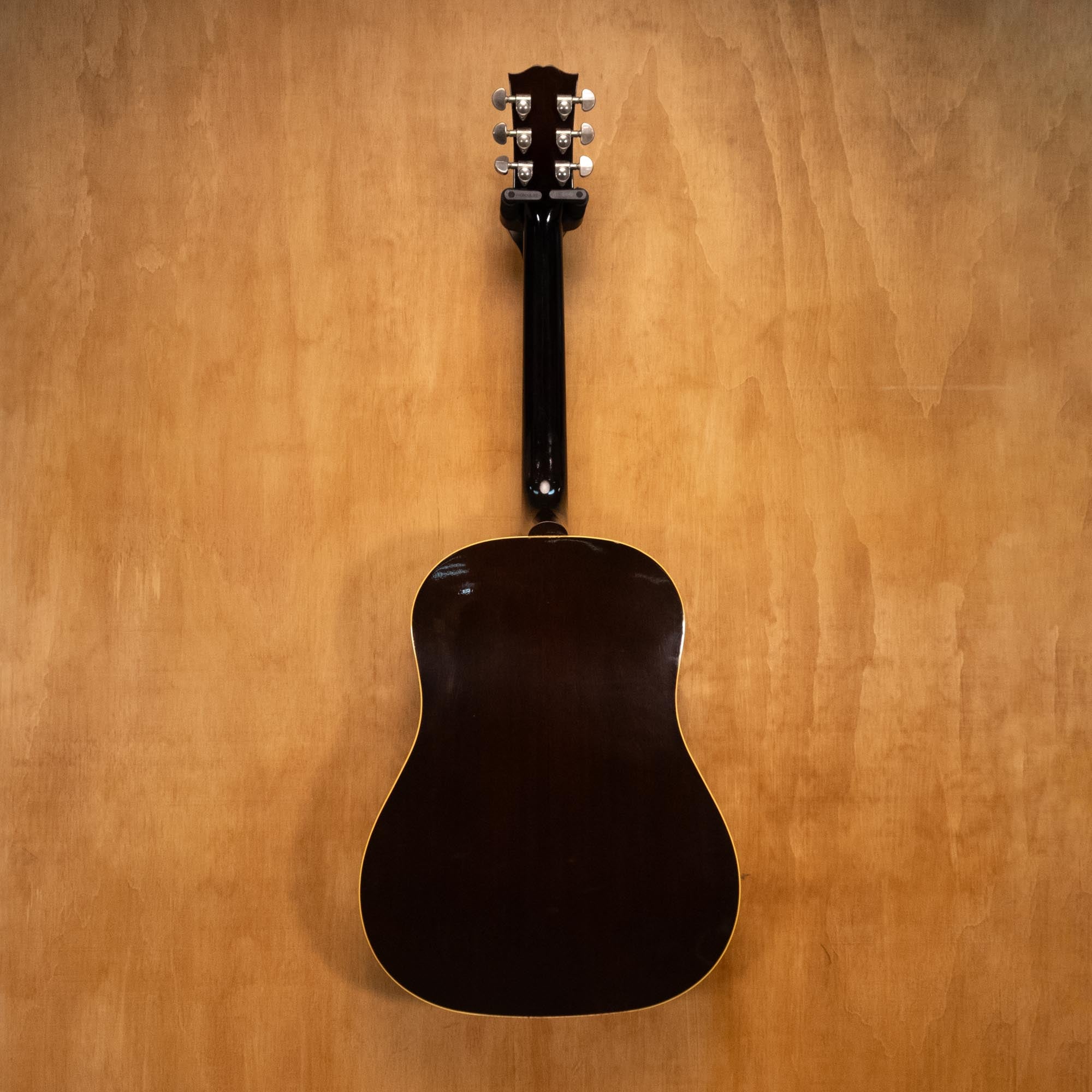 Gibson J-45 Standard acoustic guitar with sunburst finish, showing the body and fretboard of this vintage-style Gibson acoustic.