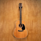 Preloved Martin D-28 dreadnought acoustic guitar with rich wood finish and six steel strings, shown in a close-up shot.