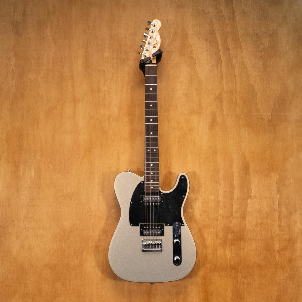 Fender Standard Telecaster HH electric guitar in Ghost Silver, showing the solid body, pickups, and maple neck.