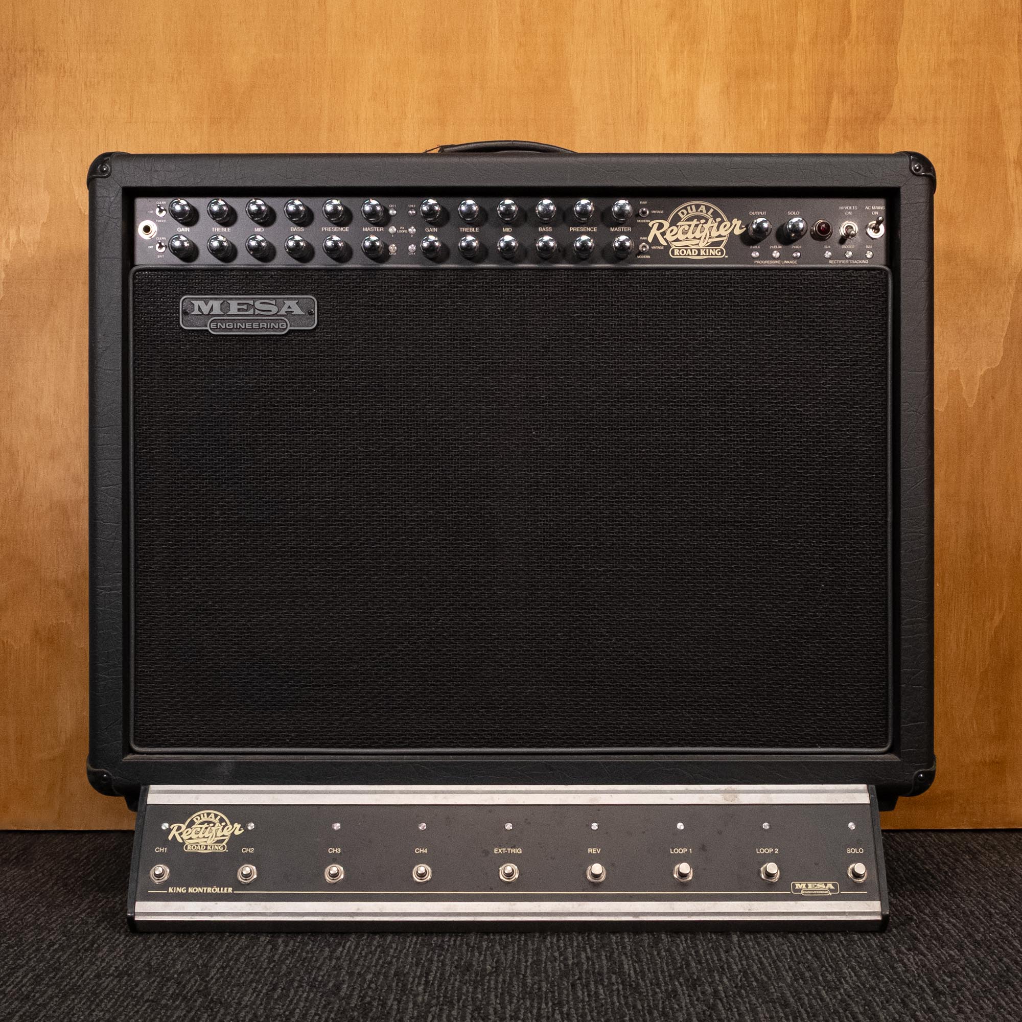 Mesa Boogie Road King 2x12 guitar amplifier combo with control knobs, speaker grille, and handles visible in the image.