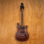 Preloved Cort M200 electric guitar with a sleek body, six strings, and pickups, displayed on a stand.