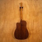 Maton Tommy Emmanuel TE1 acoustic guitar with natural wood finish, six strings, and detailed fretboard, shown from a front angle.