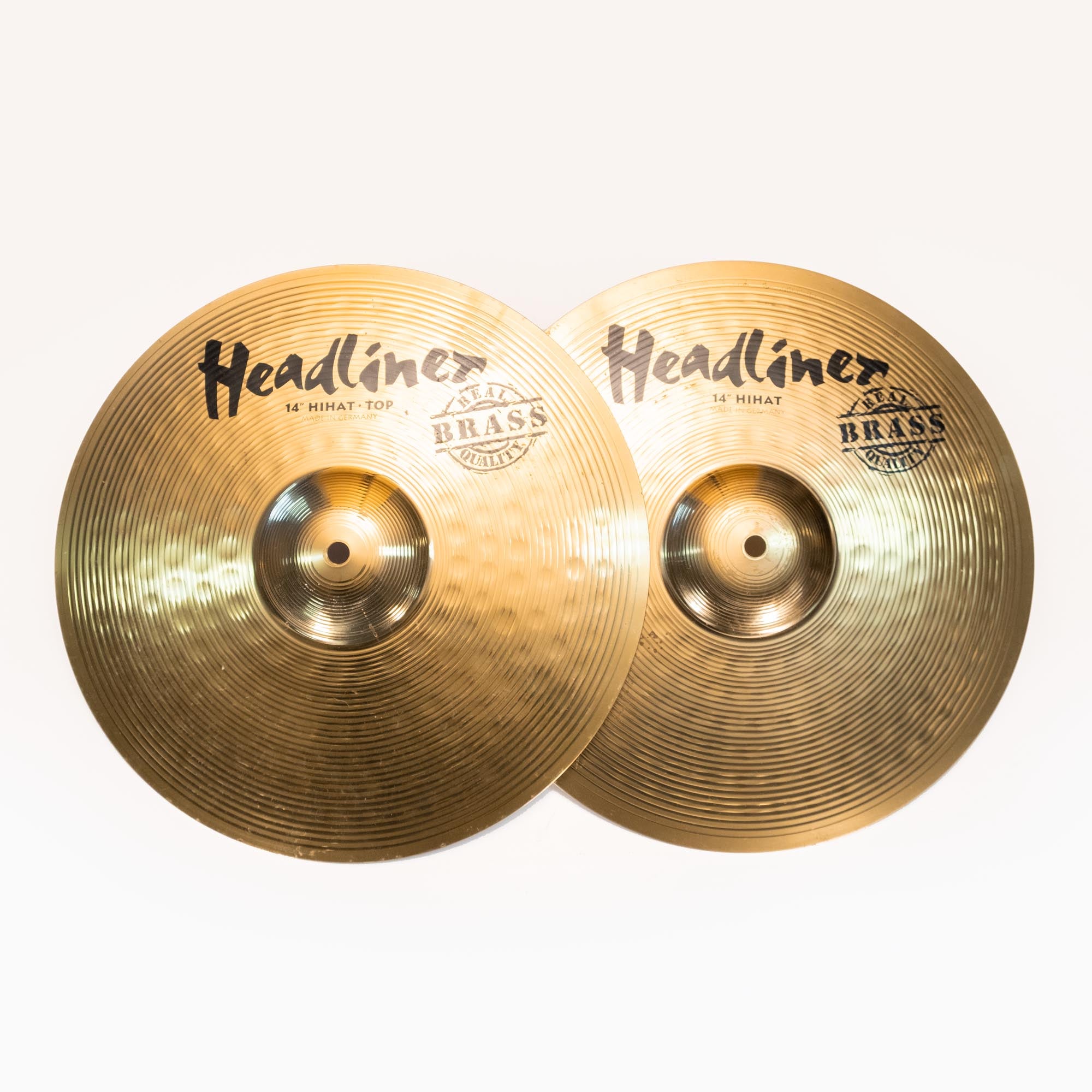 Pair of preowned Headliner 14-inch Hi-hat cymbals, single cymbals with a shiny metallic finish, used for drum sets.