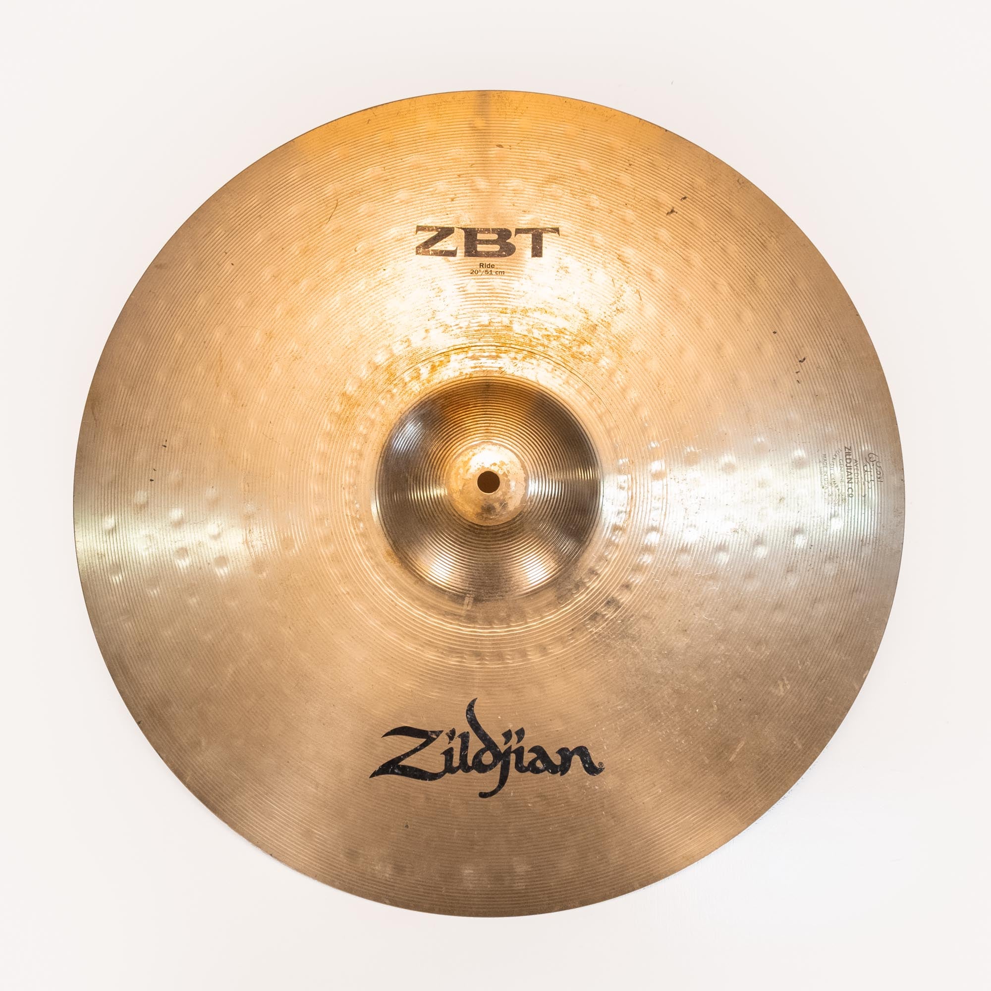Preloved Zildjian ZBT 20-inch ride cymbal showing the shiny metal surface and detailed branding on the top.