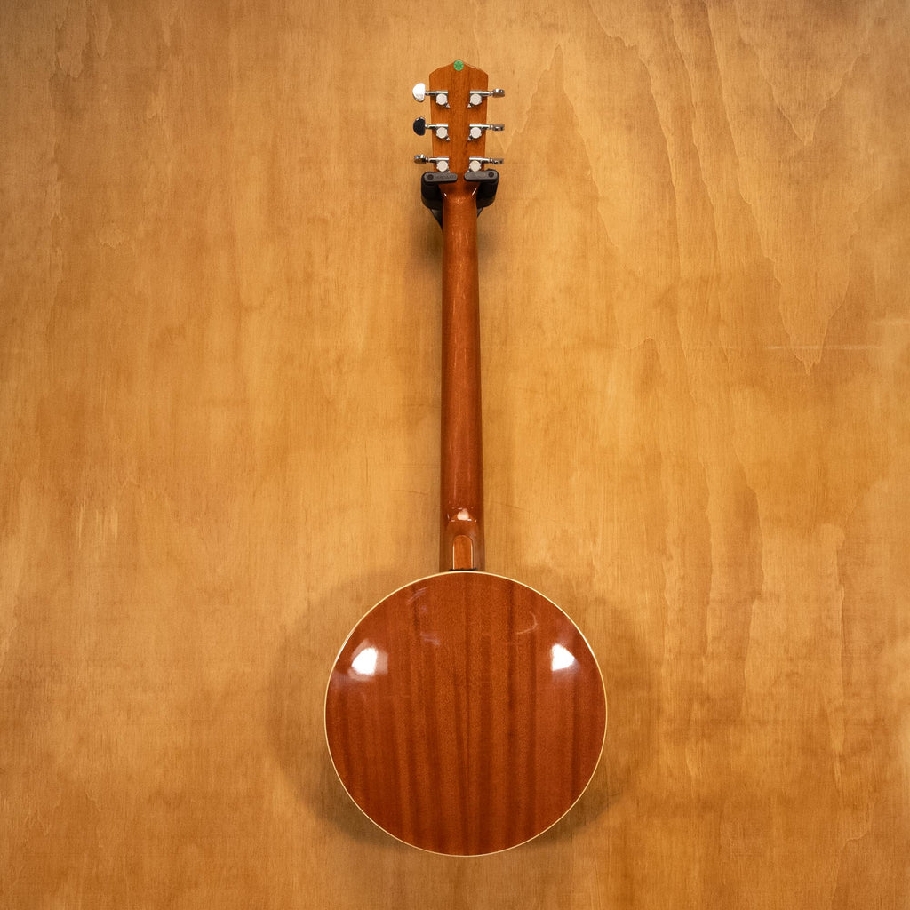Preloved Cort 6-string Git-Banjo with wooden body and metal strings, suitable for folk and bluegrass music.