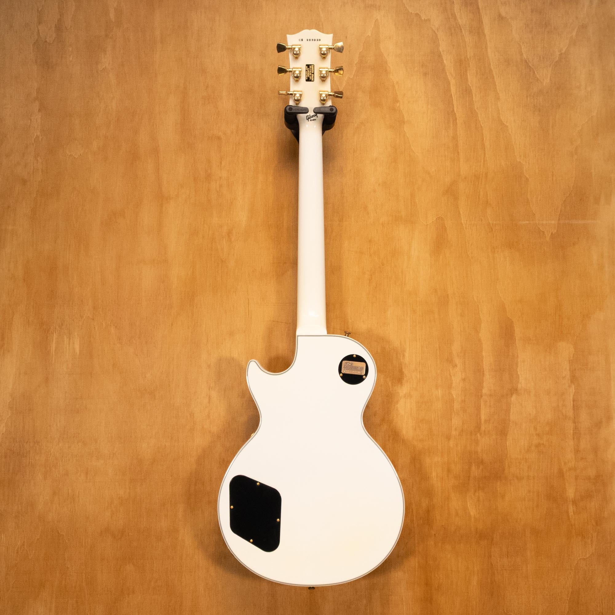 Gibson Les Paul Custom electric guitar in Alpine White, 2006 model, showing the body and neck with gold hardware details.