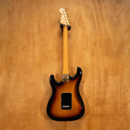 Fender SRV Stratocaster '04 electric guitar with sunburst finish, maple neck, and three pickups, showcased on a stand.
