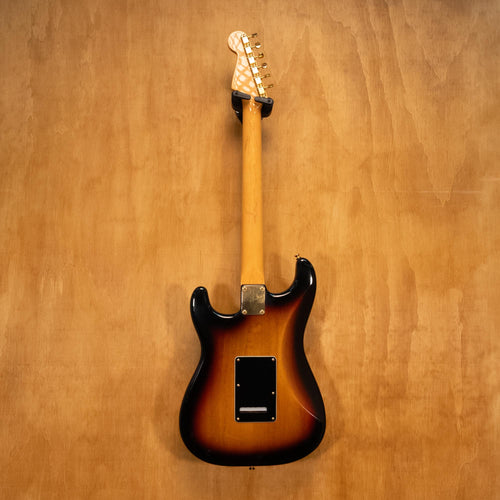 Fender SRV Stratocaster '04 electric guitar with sunburst finish, maple neck, and three pickups, showcased on a stand.