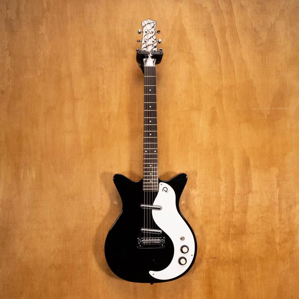 Danelectro '59M NOS electric guitar in black with vintage-style body and chrome hardware, shown on a plain background.