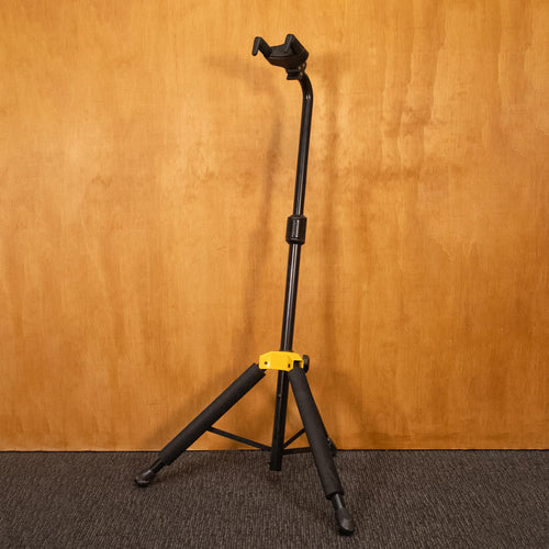 Preloved Hercules Auto Grab Guitar Stand with padded arms and sturdy metal frame for secure guitar storage.