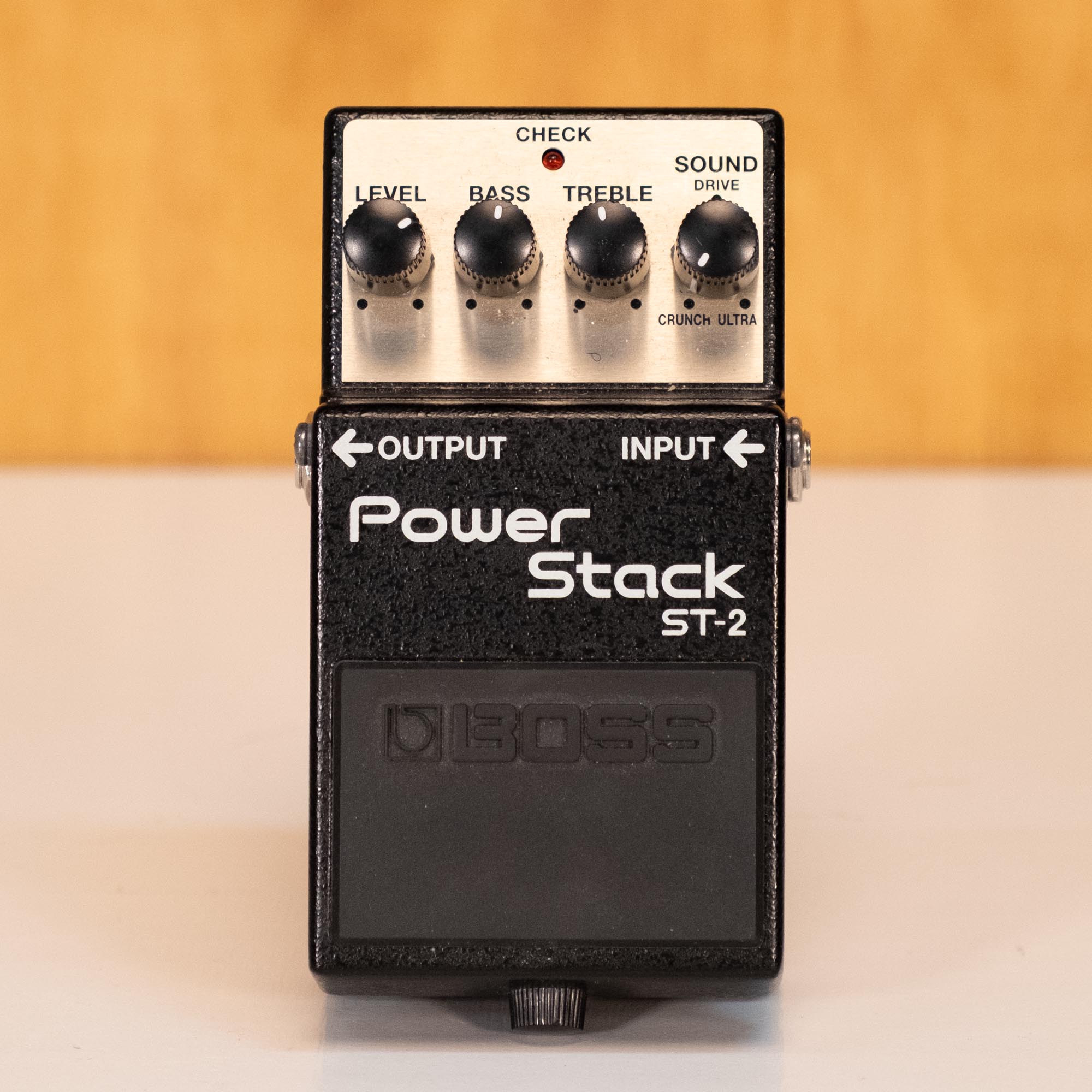 BOSS ST-2 Power Stack guitar effects pedal, close-up of the black pedal with control knobs and input jacks.