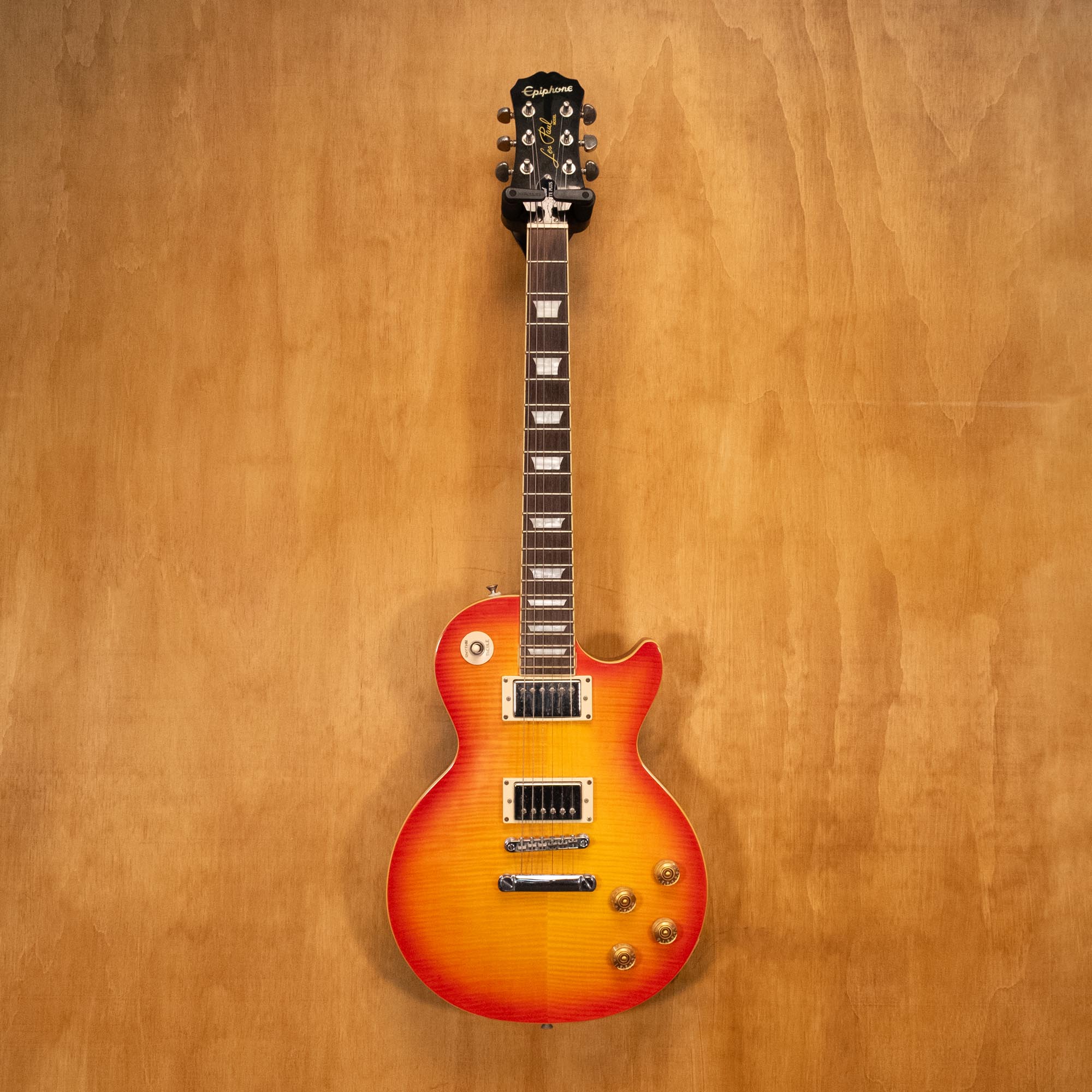 Epiphone Les Paul 1960 Tribute Pro electric guitar with sunburst finish and chrome hardware, close-up of body and pickups.